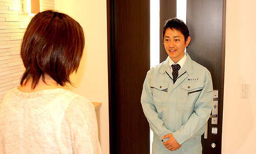 作業員を見送る女性